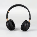Matte black wireless over-ear headphones with gold accents