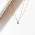 Fine gold chain necklace with round pendant