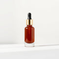 Amber glass serum bottle with gold dropper cap